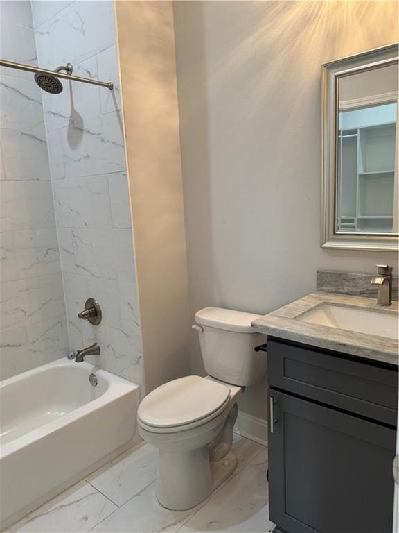 full bathroom featuring vanity, tiled shower / bath, and toilet