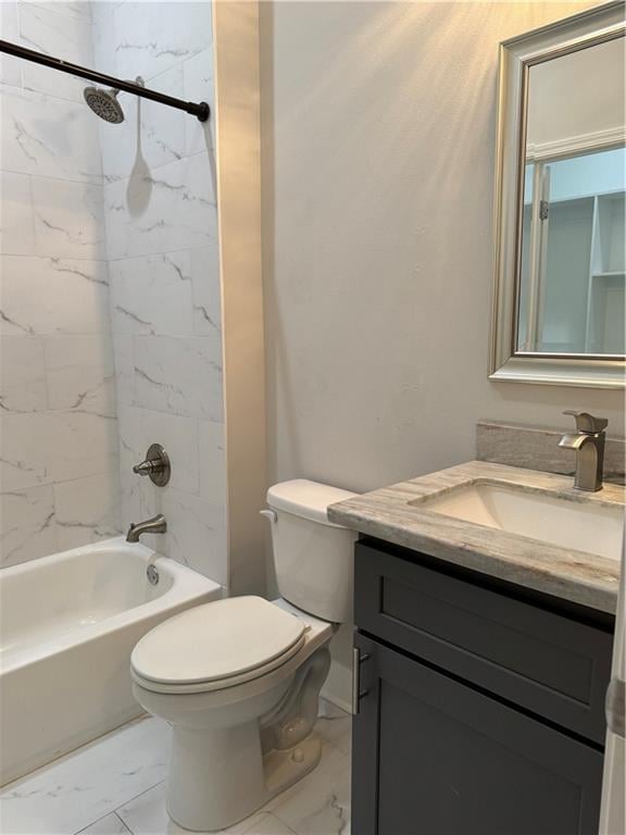 full bathroom with tiled shower / bath, toilet, and vanity