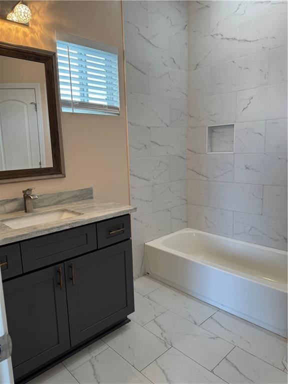 bathroom with vanity and tiled shower / bath