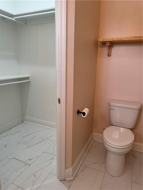 bathroom featuring a skylight and toilet