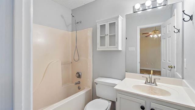 full bathroom with vanity, a textured ceiling, toilet, washtub / shower combination, and ceiling fan