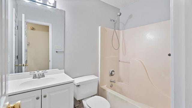 full bathroom featuring vanity, toilet, and  shower combination