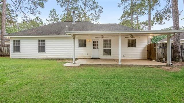 back of property with a patio, a lawn, and ceiling fan