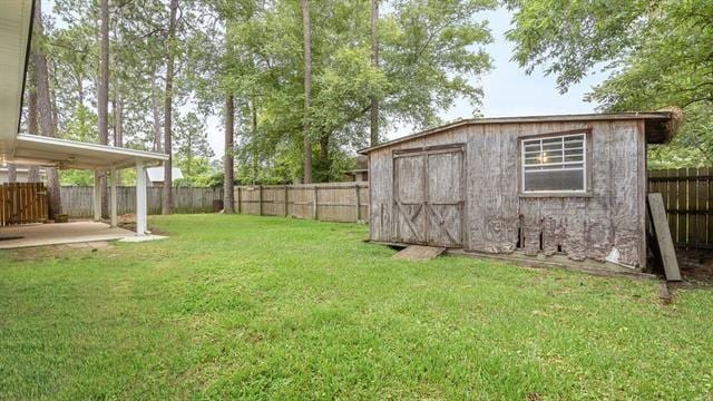 view of yard featuring a shed and a patio