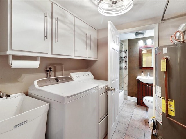 laundry area with water heater, sink, light tile patterned floors, and independent washer and dryer