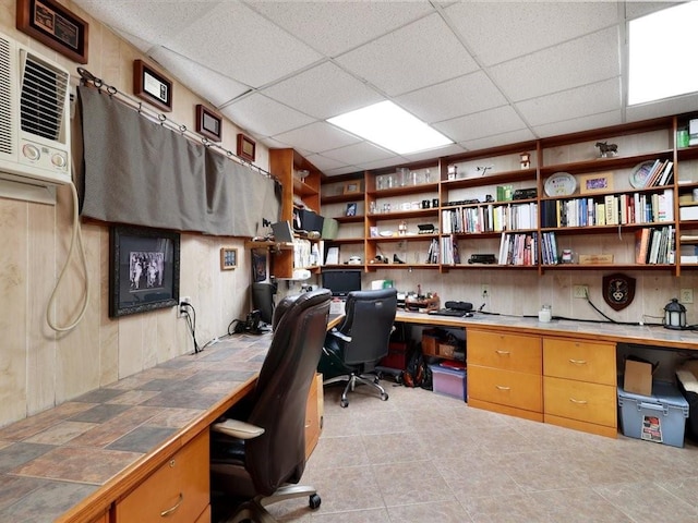 home office with a paneled ceiling and light tile patterned flooring