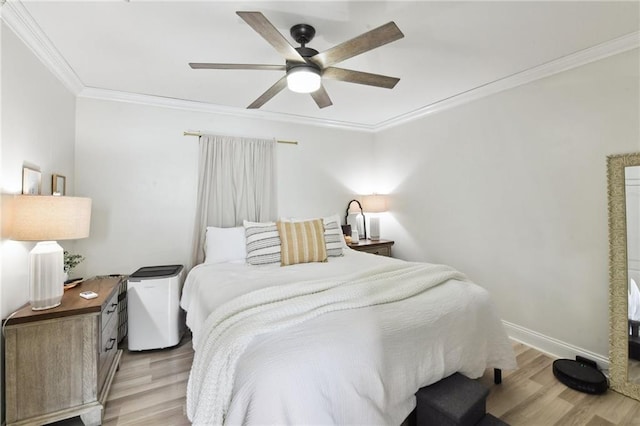 bedroom with ceiling fan, light wood-type flooring, and ornamental molding