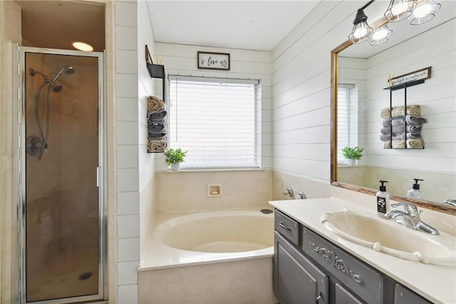 bathroom featuring plus walk in shower, vanity, and wooden walls