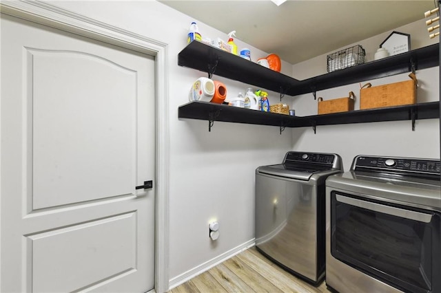 washroom featuring washer and clothes dryer and light wood-type flooring