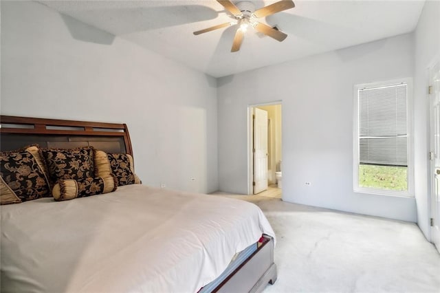 carpeted bedroom featuring ceiling fan and connected bathroom