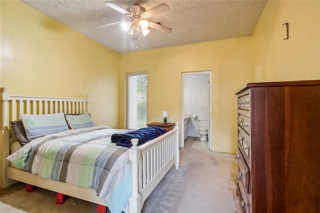 carpeted bedroom featuring connected bathroom, a textured ceiling, and ceiling fan