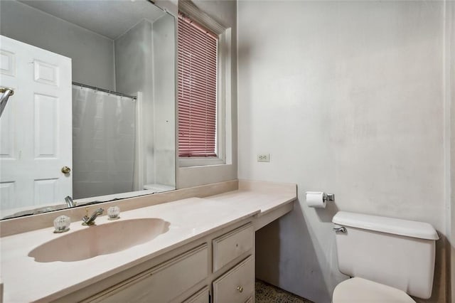 bathroom featuring vanity, toilet, and a shower with curtain