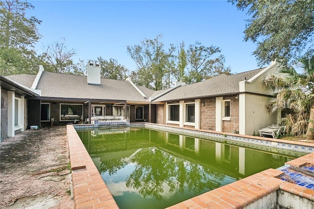 back of property featuring a patio and a water view