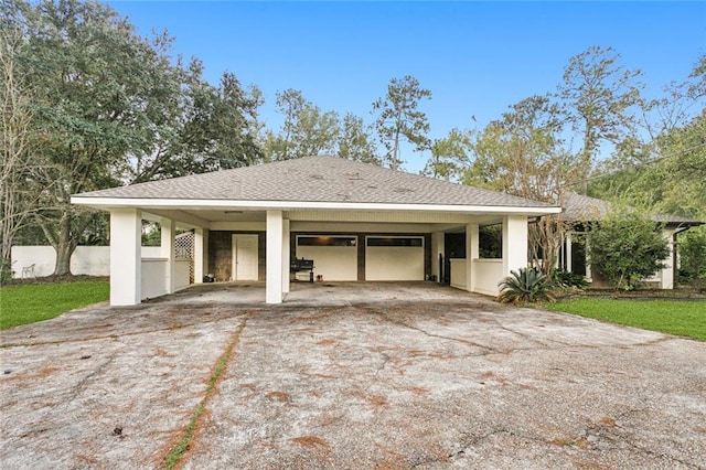 view of front of house featuring a garage and a carport