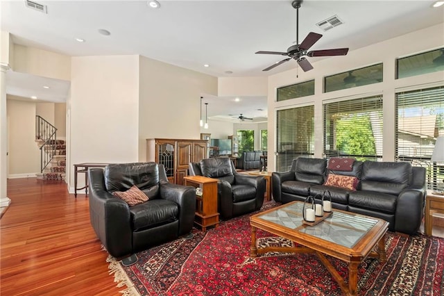 living room with hardwood / wood-style floors and ceiling fan