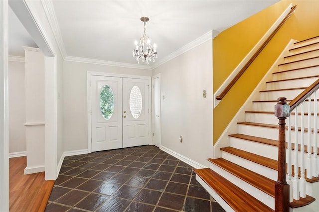 foyer with stairs, a notable chandelier, and ornamental molding