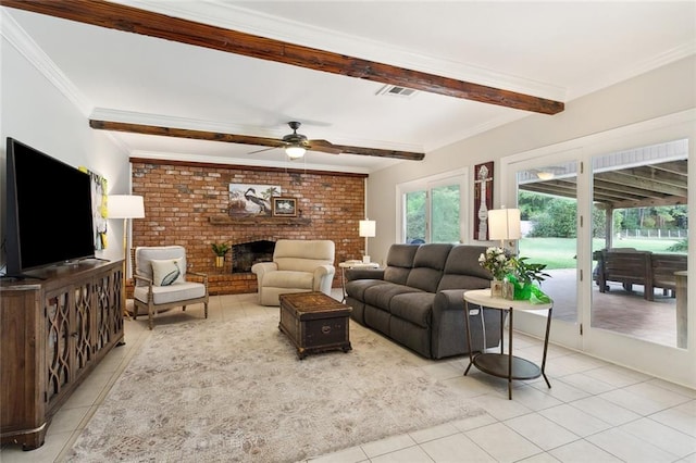 tiled living room with crown molding, a brick fireplace, beamed ceiling, ceiling fan, and brick wall