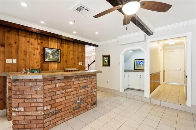 bar featuring crown molding, wood walls, light tile patterned flooring, ceiling fan, and visible vents