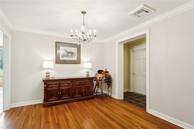 hallway featuring hardwood / wood-style flooring, a chandelier, and ornamental molding