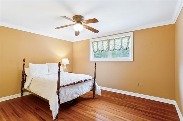 bedroom with wood-type flooring, ceiling fan, and crown molding