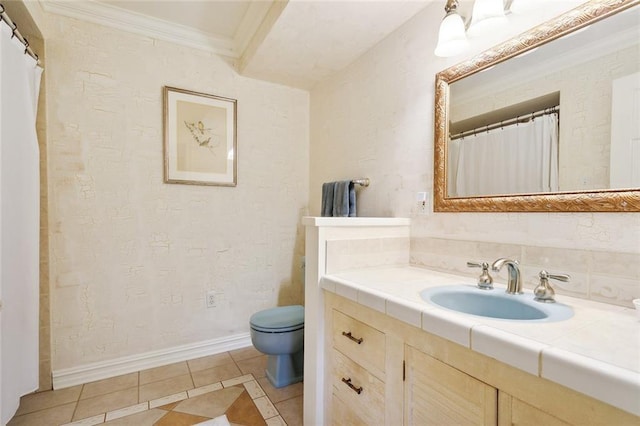 bathroom with vanity, crown molding, toilet, baseboards, and tile patterned floors