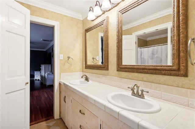 bathroom with hardwood / wood-style floors, vanity, and crown molding