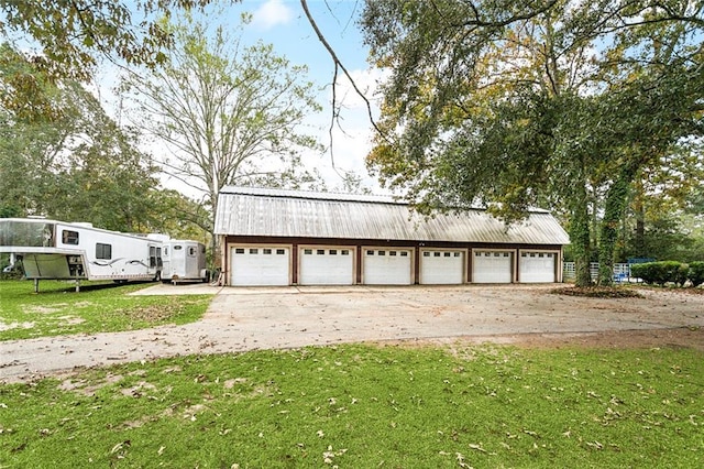 garage featuring a lawn