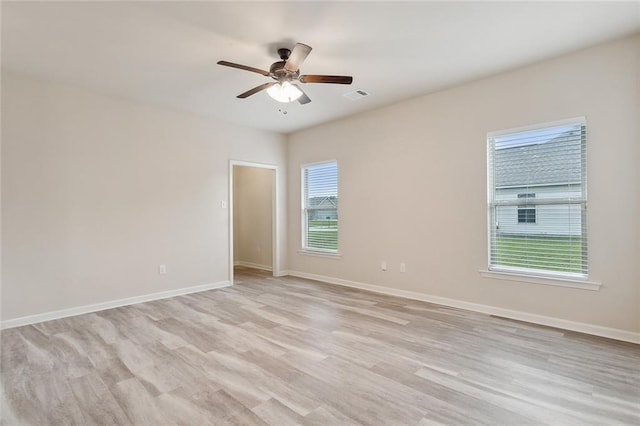 unfurnished room with light wood-type flooring, ceiling fan, and a healthy amount of sunlight