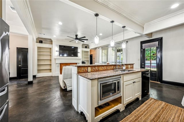 kitchen with stone counters, a center island with sink, decorative light fixtures, and sink