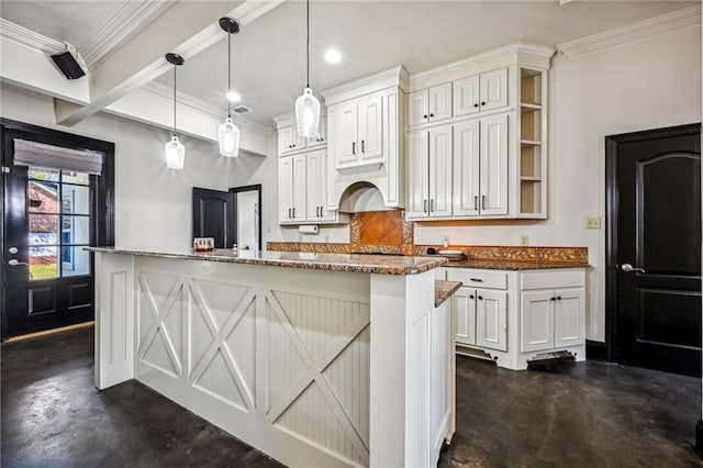 kitchen featuring pendant lighting, white cabinetry, and a kitchen island with sink