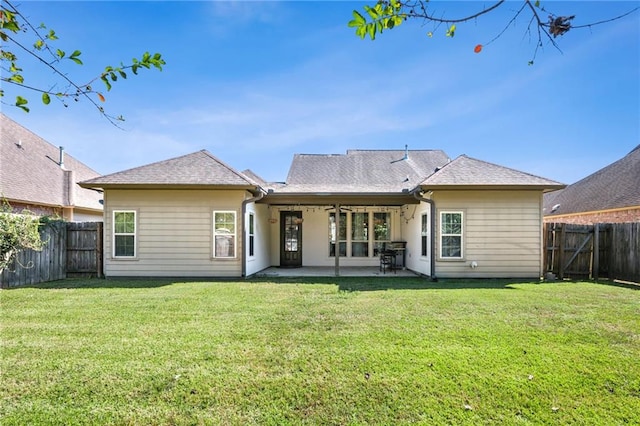 back of property featuring a patio area and a yard