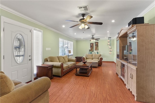 living room featuring ceiling fan, light hardwood / wood-style floors, and crown molding