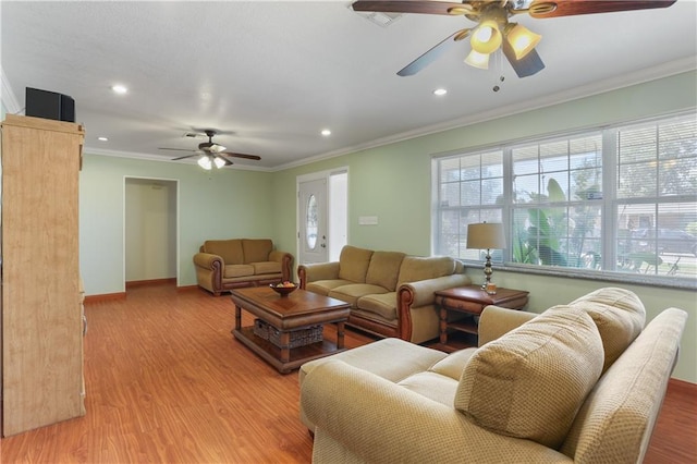 living room featuring ornamental molding, light wood-type flooring, and ceiling fan