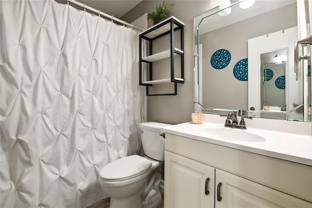 bathroom with walk in shower, vanity, and toilet