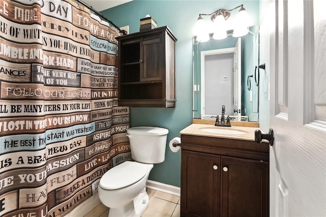 bathroom featuring toilet, vanity, tile patterned floors, and walk in shower