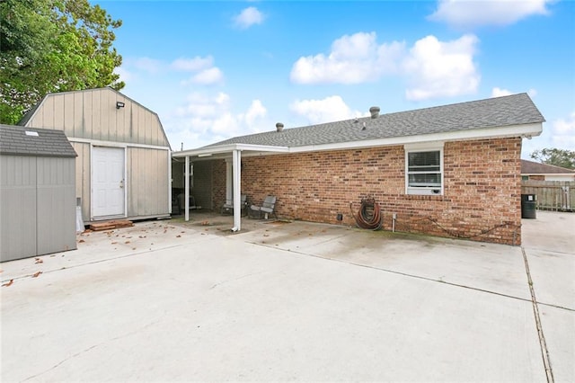 rear view of house featuring a shed and a patio area