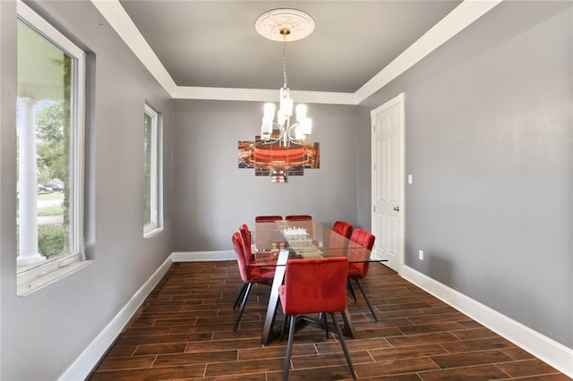 dining area featuring dark hardwood / wood-style flooring, a notable chandelier, and crown molding