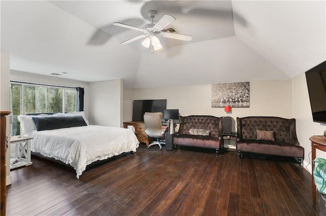 bedroom featuring dark wood-type flooring, vaulted ceiling, and ceiling fan