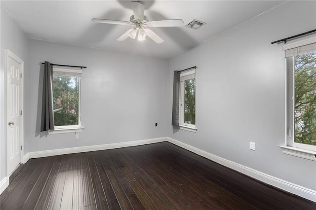 spare room featuring hardwood / wood-style floors, a healthy amount of sunlight, and ceiling fan