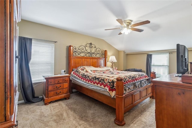 bedroom featuring ceiling fan, vaulted ceiling, and light colored carpet