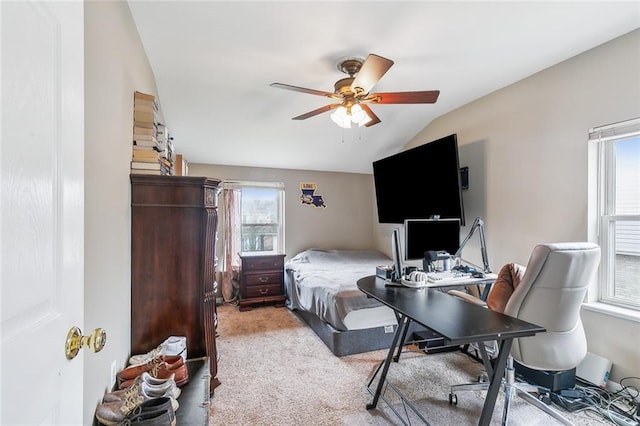 bedroom featuring light colored carpet, lofted ceiling, multiple windows, and ceiling fan