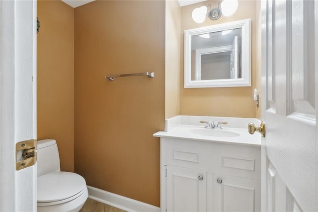 bathroom with vanity, tile patterned floors, and toilet