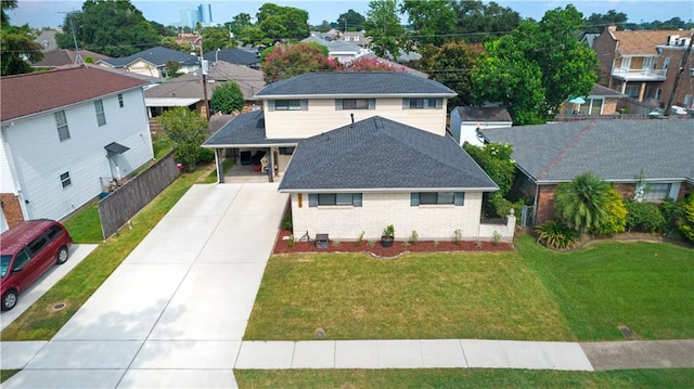 view of front of home featuring a front lawn and a carport