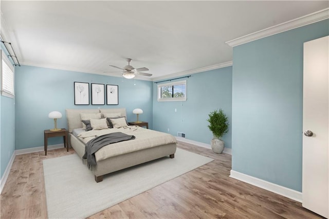 bedroom with hardwood / wood-style floors, ceiling fan, and ornamental molding