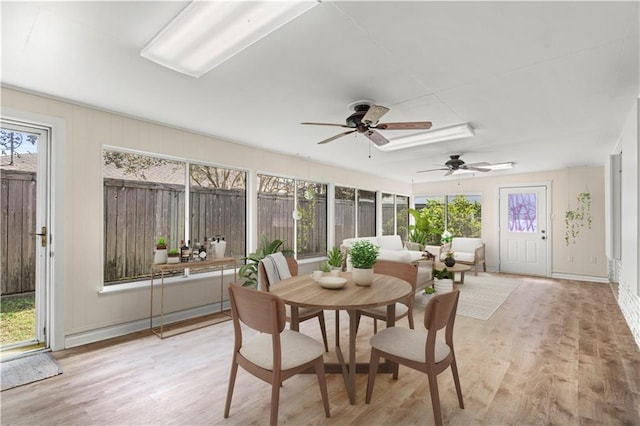 sunroom / solarium featuring ceiling fan