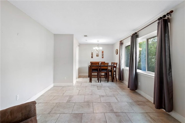 dining space featuring a chandelier and light tile patterned floors