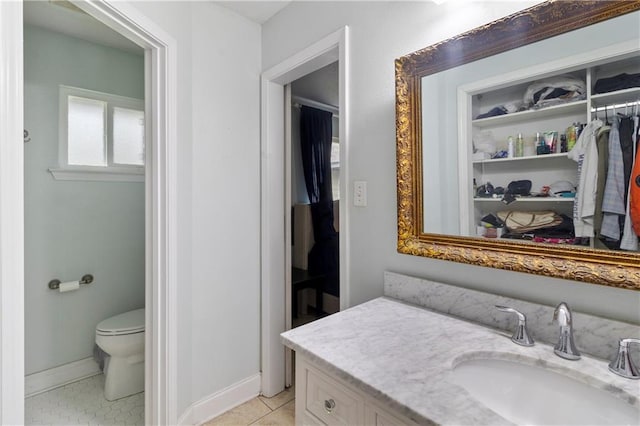 bathroom with vanity, tile patterned floors, and toilet