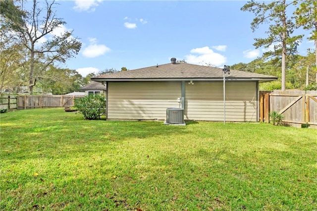 view of side of home featuring cooling unit and a lawn