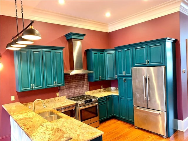 kitchen with stainless steel appliances, crown molding, sink, wall chimney range hood, and decorative light fixtures