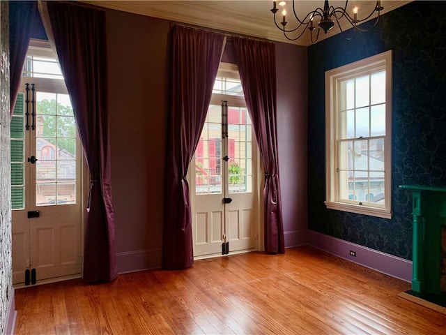 interior space featuring a chandelier, plenty of natural light, and light hardwood / wood-style floors